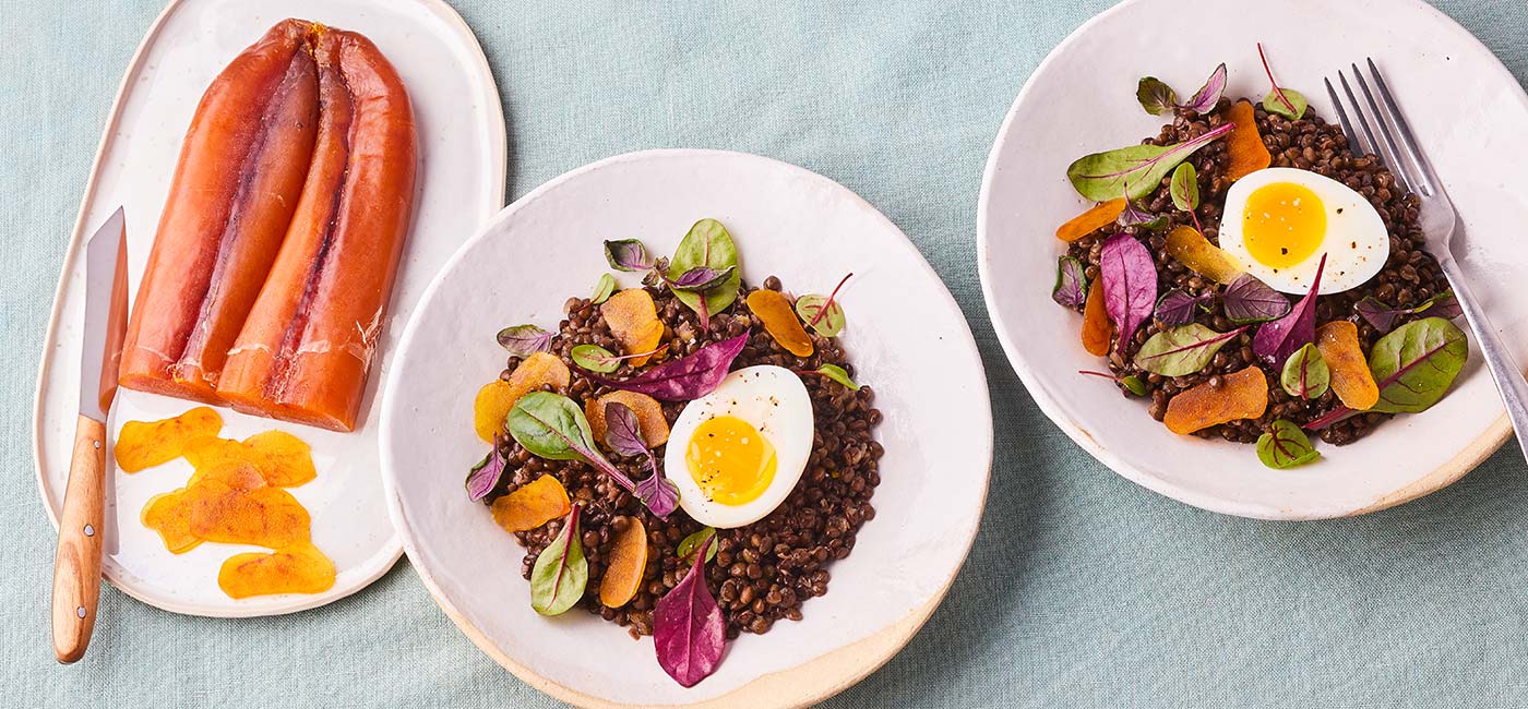 Beluga lentil salad, soft-boiled eggs, baby leaf salad and Bottarga